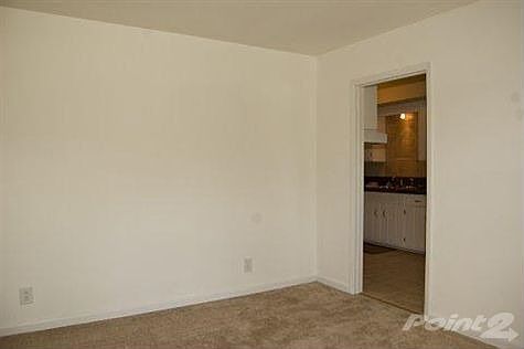 Generous living room with fresh paint and new carpet. Easy access to other areas of the home.