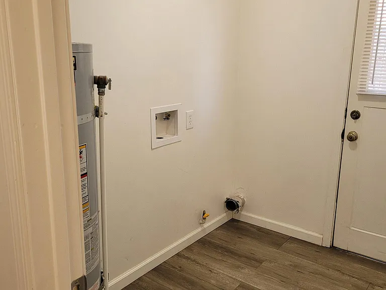Laundry room with water heater and washer/dryer hookups for a gas dryer.