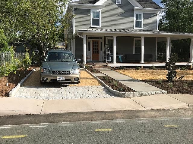 Tenant parking spot with upstairs apartment entry on front left corner of house (side door).
