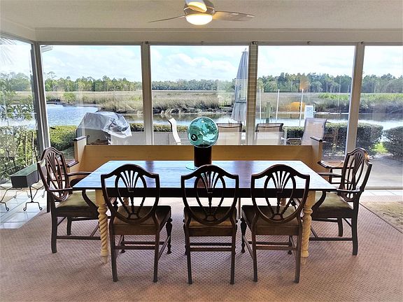 Left side of Lanai with handmade farm table, church pew & five chairs. Plenty of space for company.