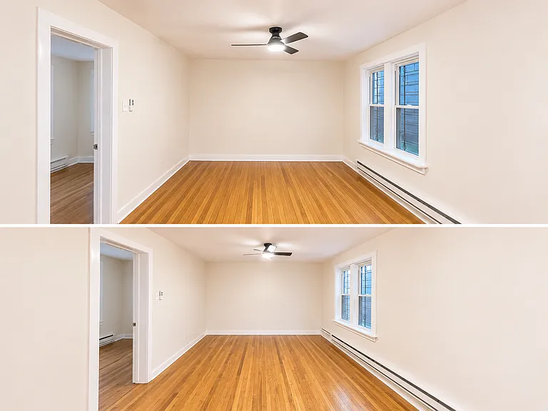 wide angle view of the living area and doorway to the second bedroom from the kitchen area