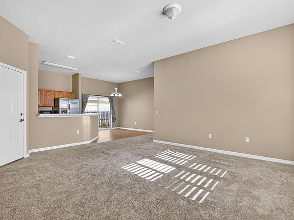 Open floor plan connecting the living room with the kitchen and dining area.