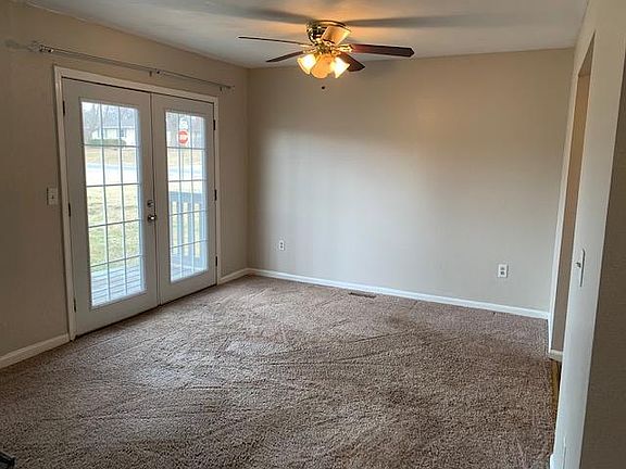 Modern French doors walk out to ground level private enclosed gated deck.