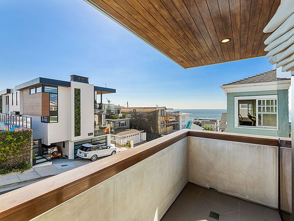 The prime bedroom features a small balcony - perfect for your morning surf check.