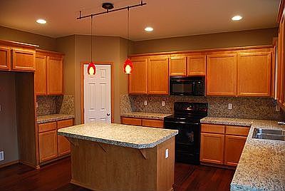 Kitchen with granite counters and hardwood floors