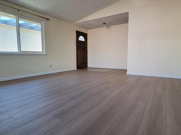Spacious living room with tall vaulted ceiling