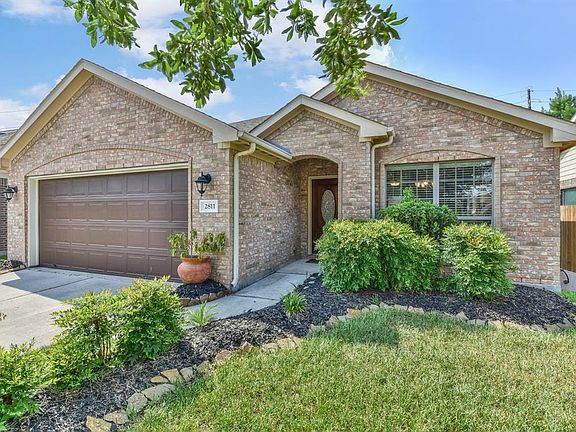 This home is move-in ready and surrounded by beautiful landscaping.