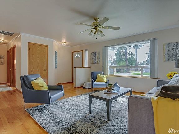 Large picture window allows ample natural light and views of the beautifully landscaped front yard.