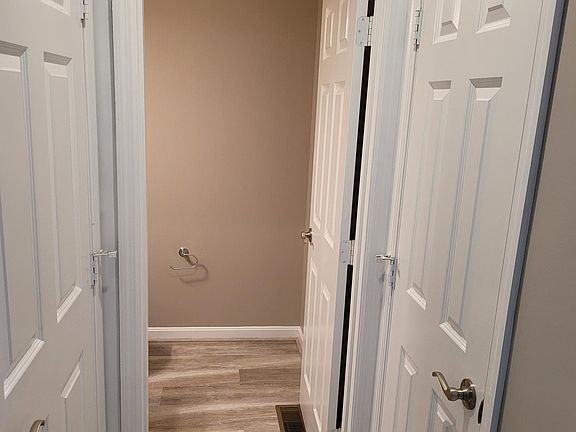 First Floor Powder Room just off of the entry also features new durable Shaw vinyl plank flooring