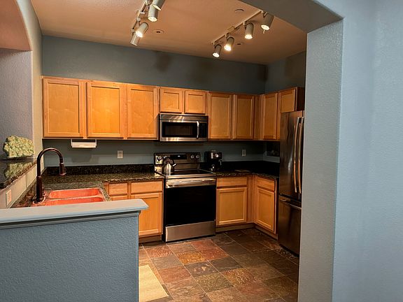 Copper sink, stainless steel appliances, and slate flooring