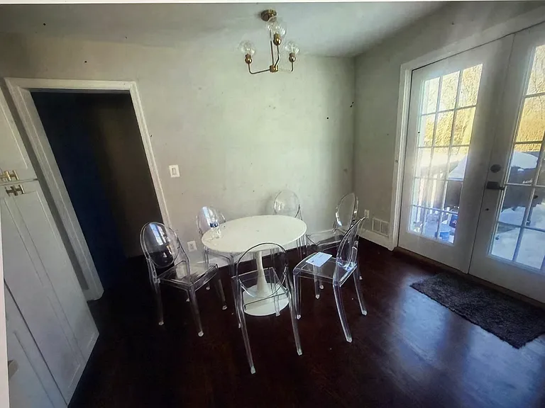 Bathed in natural light, the charming breakfast nook offers the perfect setting for casual dining or morning coffee, with sliding glass doors providing seamless access to the deck and beautifully landscaped backyard.