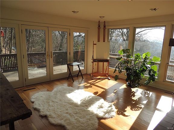 Second living room with French doors with wrap around deck to enjoy the views
