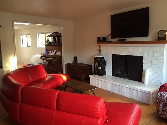 Living room with firepace view to breakfast area