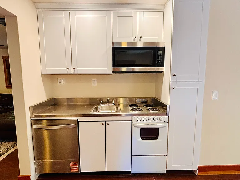 Kitchen with Dishwasher, cabinets, electric stove