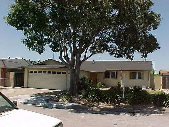 Two car garage, front tree.