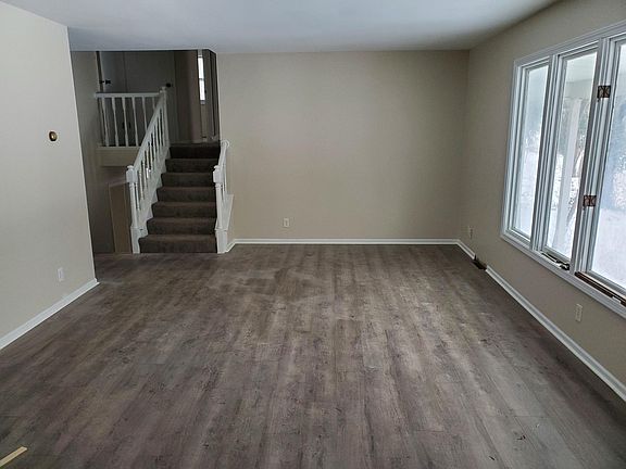 Living room and stairs up to bedrooms and down to family room.
