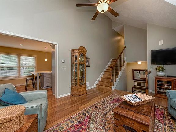 GREAT ROOM LOOKING INTO KITCHEN AND STAIRS TO UPPER LEVEL BEDROOMS