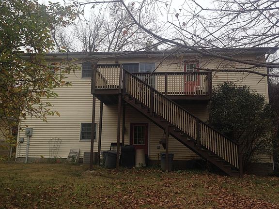 Rear of building showing small deck, rear stairs, patio doo