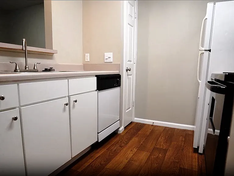 Well-maintained and functional, this classic galley-style kitchen includes a pantry and passthrough window to keep things open while you cook.