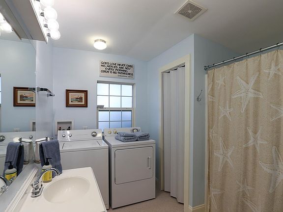main bath with shower, tub, and laundry