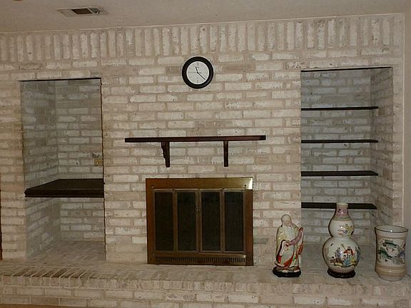 Wood burning Fire place with lots of shelving ready for your personal touches