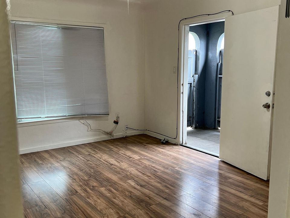 Front private patio with gate, lead to bright living room with window AC and celing fan