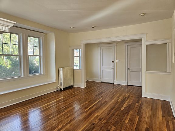 Living room w view of front door, front closet, and foyer and window seat