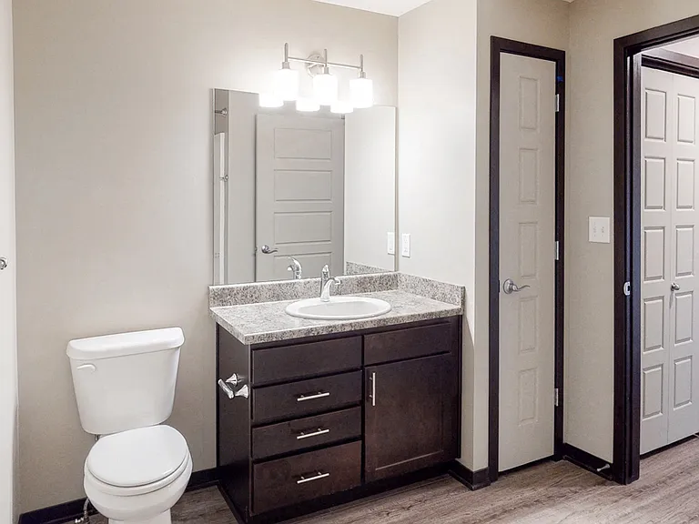 Thoughtfully designed bathrooms offer extra storage and a comfortable space to move through daily routines with ease.