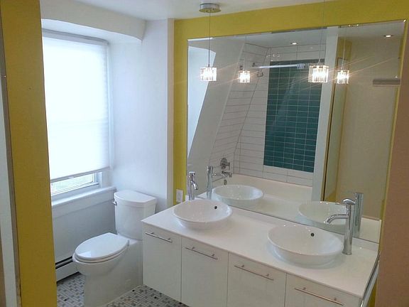 Double vanity, modern glass floor tiles, modern fixtures