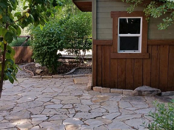 Custom garden shed with stone patio.