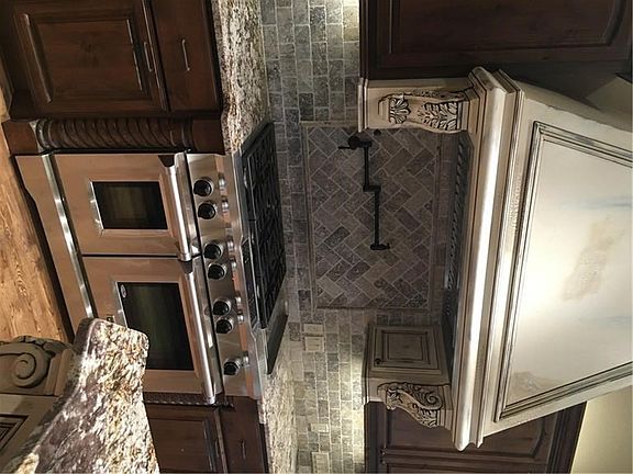 Beautiful woodwork with chef's appliances.