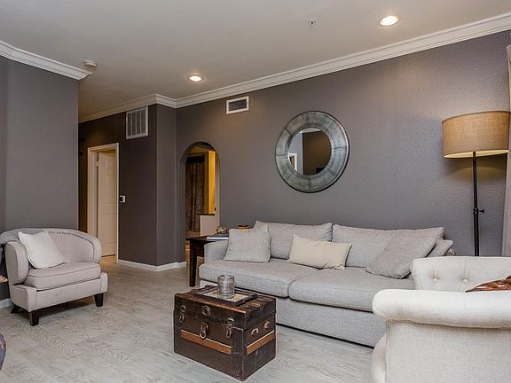 The living area is a comfortable space for daily living and entertaining.  The natural light is filtered into this area and the home features a neutral paint scheme, crown molding and recessed lighting.
