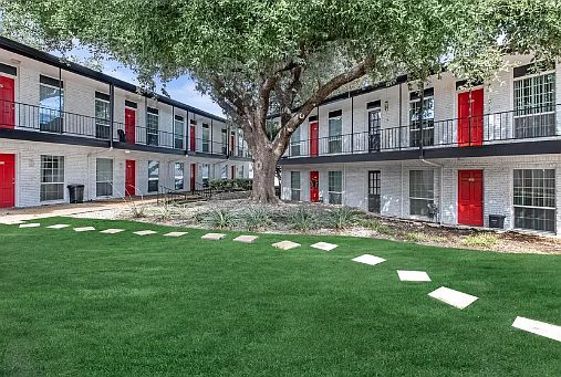 Lush, open courtyards with walking paths and mature shade trees_perfect for a peaceful afternoon outdoors.