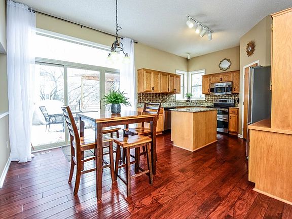 The main level is flooded with natural light from 9' patio doors and transom windows and accented with high ceilings.  Beautiful handscraped flooring warms the space.