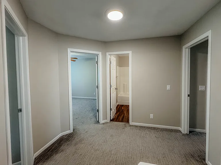 Spacious landing upstairs leads to three bedrooms and main bath.