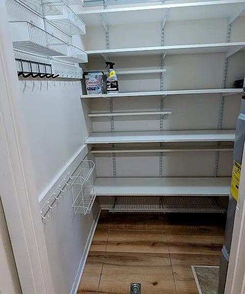 Pantry with ample shelving, storage space.
