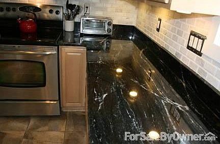 GORGEOUS BLACK AND WHITE GRANITE
						:
						Rare black with white vein imported stone top with white marble backsplash
