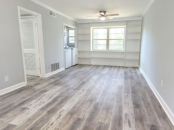 Elegantly remodeled family room with modern finishes and timeless charm with custom built-in bookcases