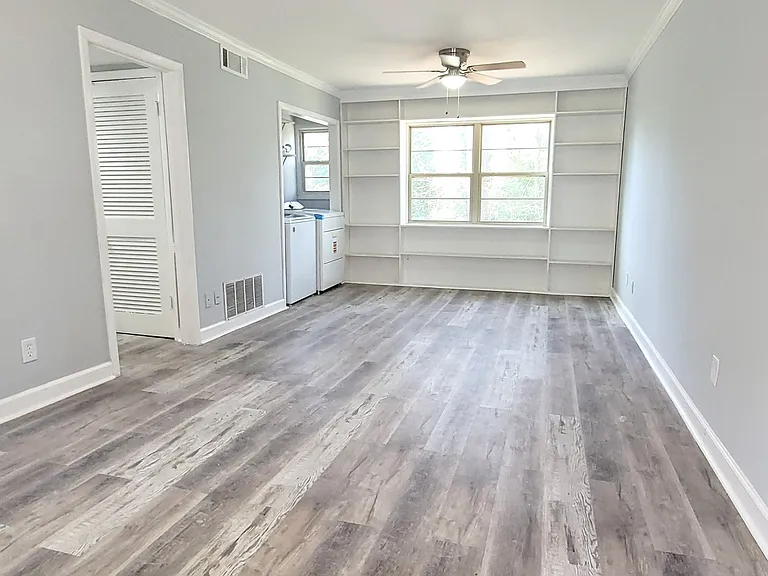 Elegantly remodeled family room with modern finishes and timeless charm with custom built-in bookcases