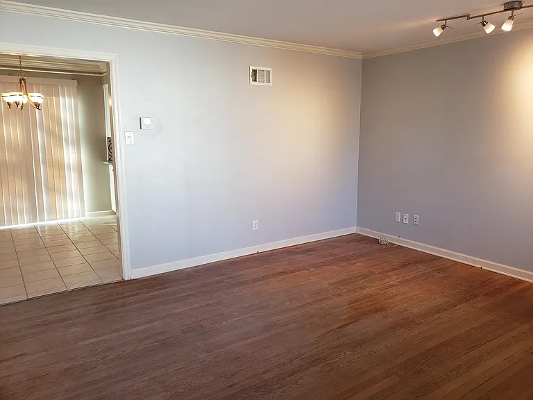 Open concept flow from living room to dining and kitchen.