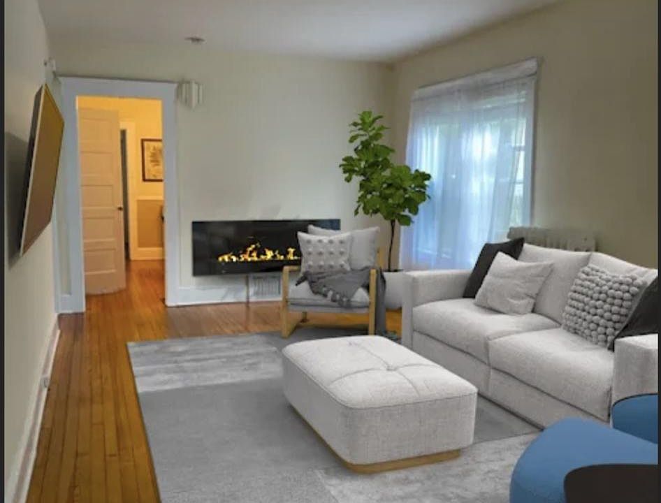 living room with large flat screen smart tv, real hardwood floors and 9'ceilings and fireplace.