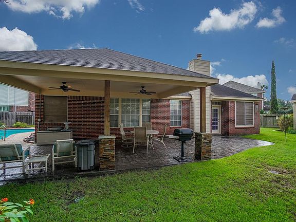 The large lot offers an inviting covered patio, pool and spa..