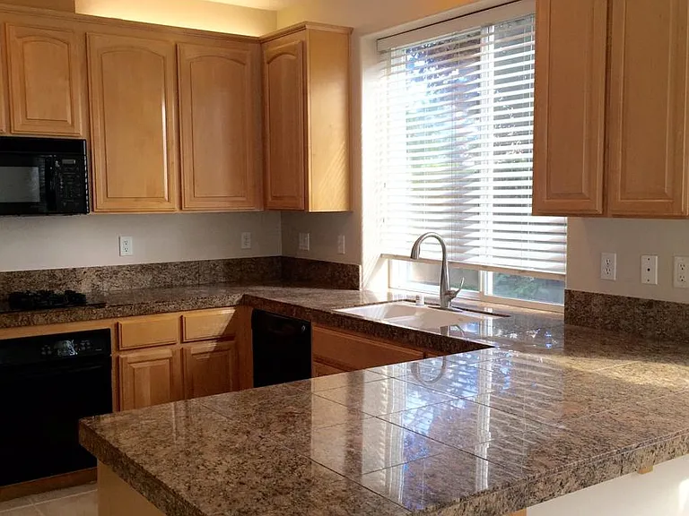 Black appliances haven been replaced with stainless steel