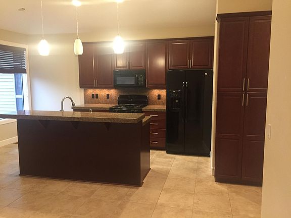 onlooking kitchen from open concept living room