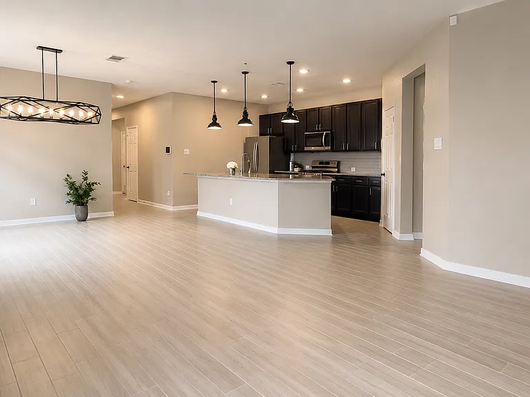 Open-concept living and dining area with clean tile flooring designed for everyday comfort