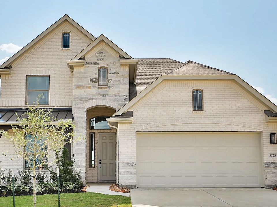 Experience refined luxury in this stone-accented facade, rustic wood beams, and verdant landscaping