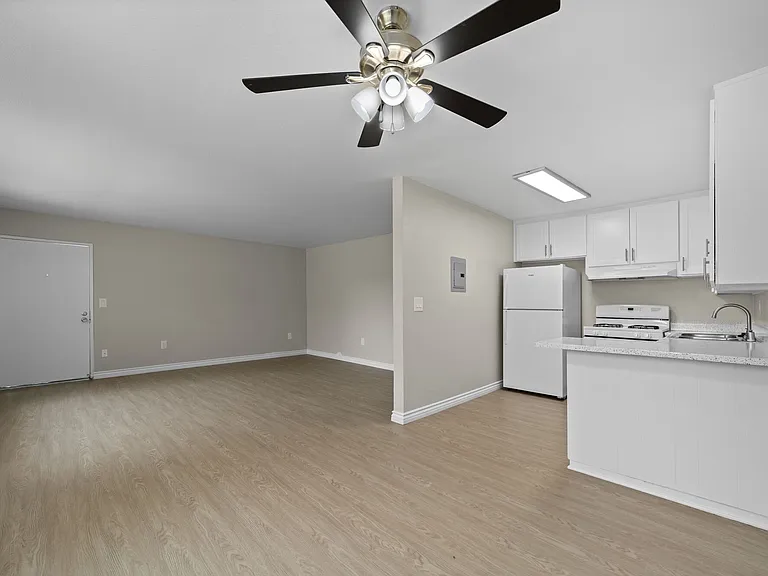 Apartment living space, dining room, and kitchen at Strada Apartments in Orange, CA
