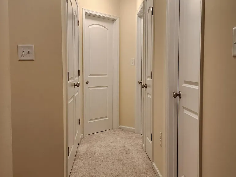 hallway, washer and dryer (left doors), bedrooms, and linen closet.
