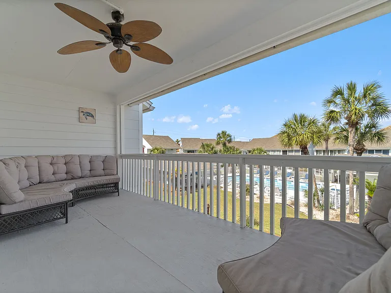Balcony with sofas overlooking the community pool