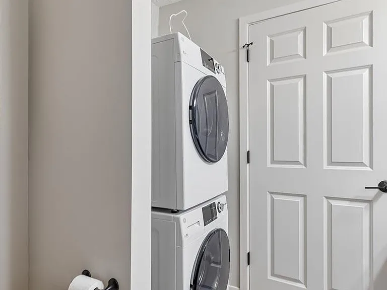 An in-home laundry area adds everyday convenience with a clean, streamlined design that keeps essentials close at hand.